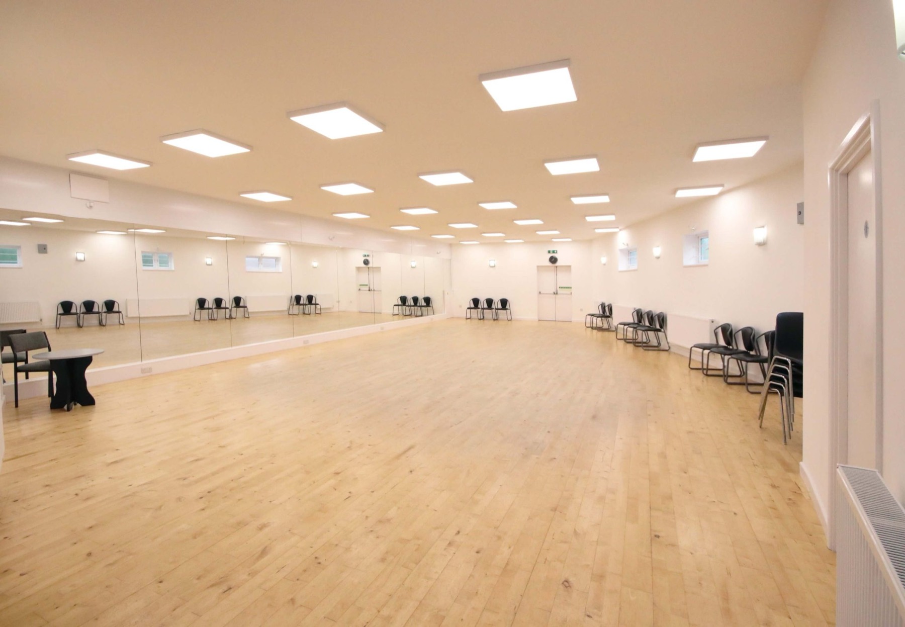 The full studio floor from the corner with the mirror wall on the left